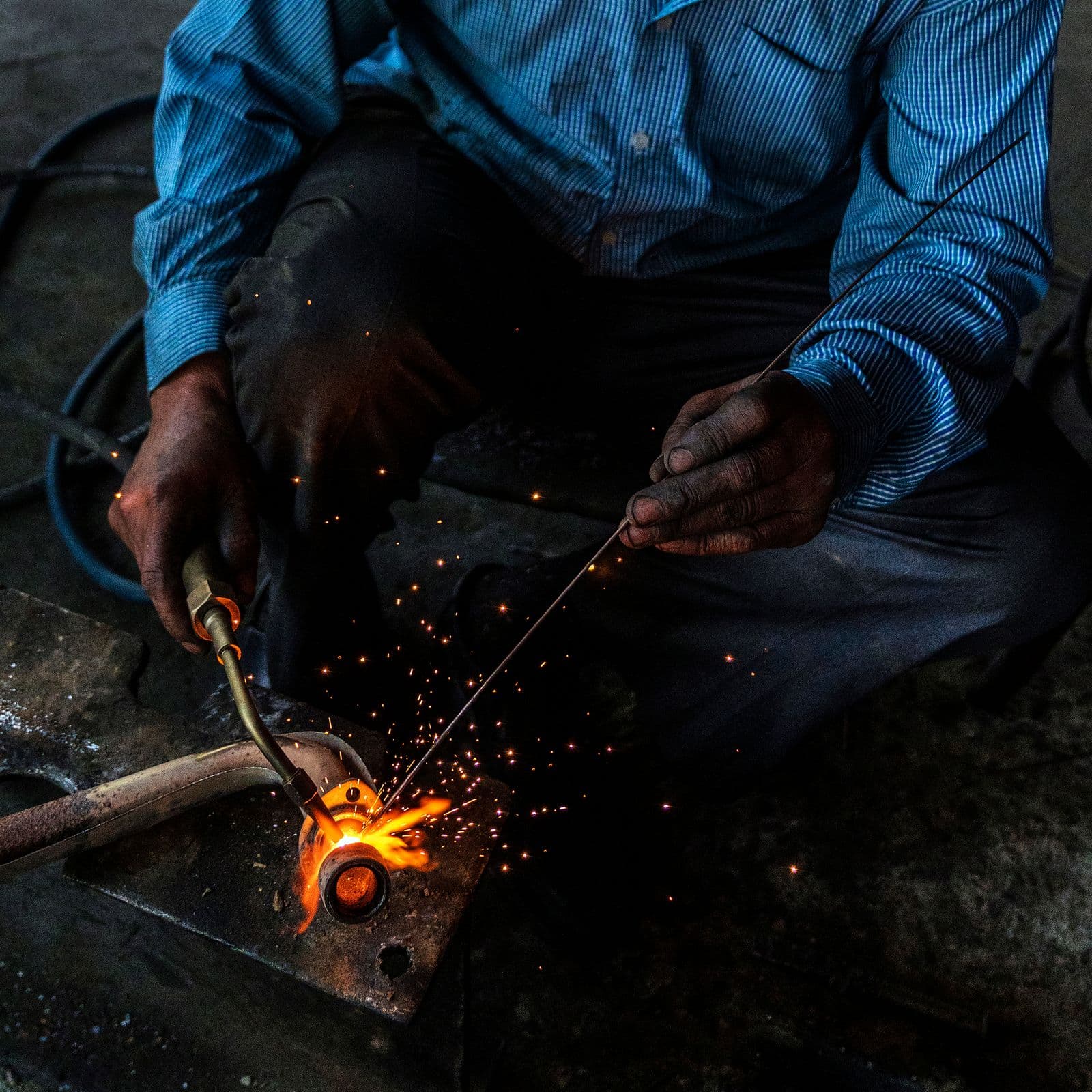 Steel worker welding a pipe joint